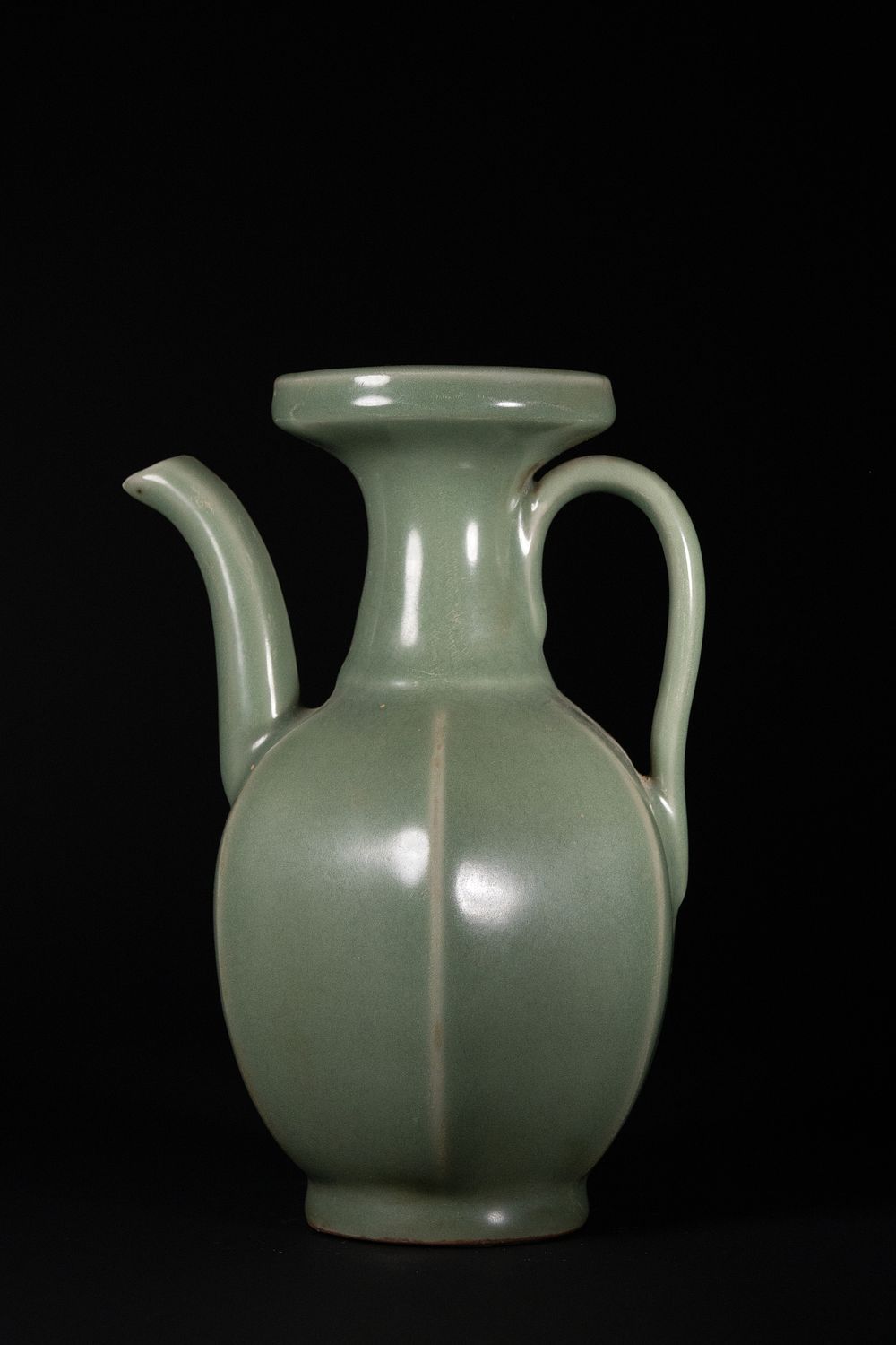 Lot 401: A Chinese Celadon-Glazed Porcelain Ewer with Grooved Panels.