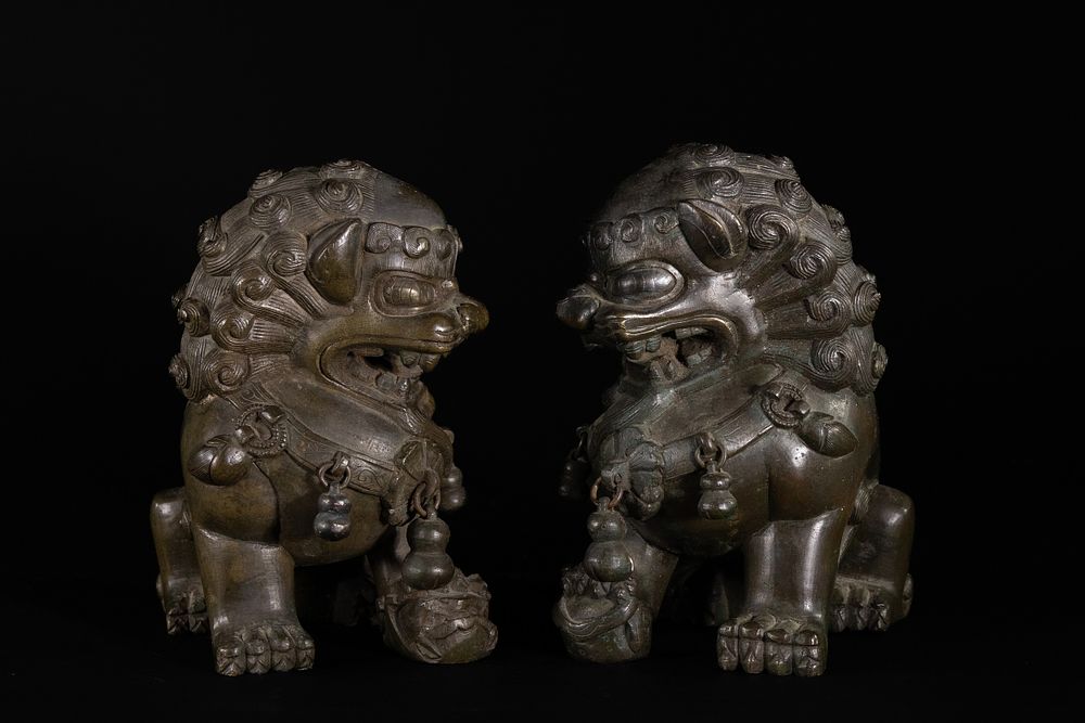 Lot 409: A Pair of Chinese Bronze Foo Dog Guardian...