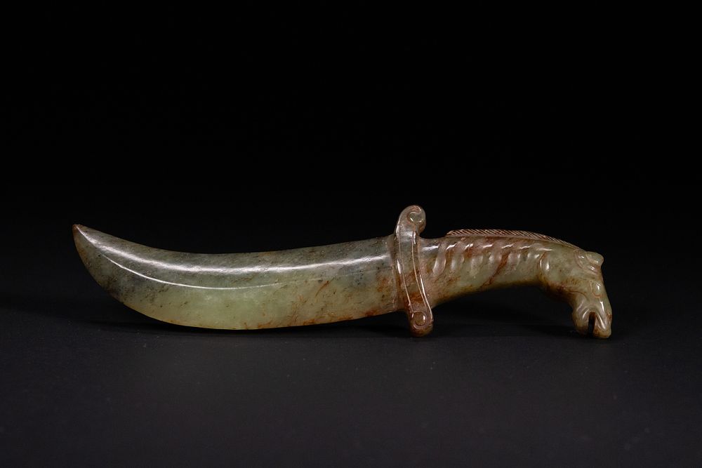 Lot 414: A Chinese Green Jade Dagger with Horse-Head Pommel.