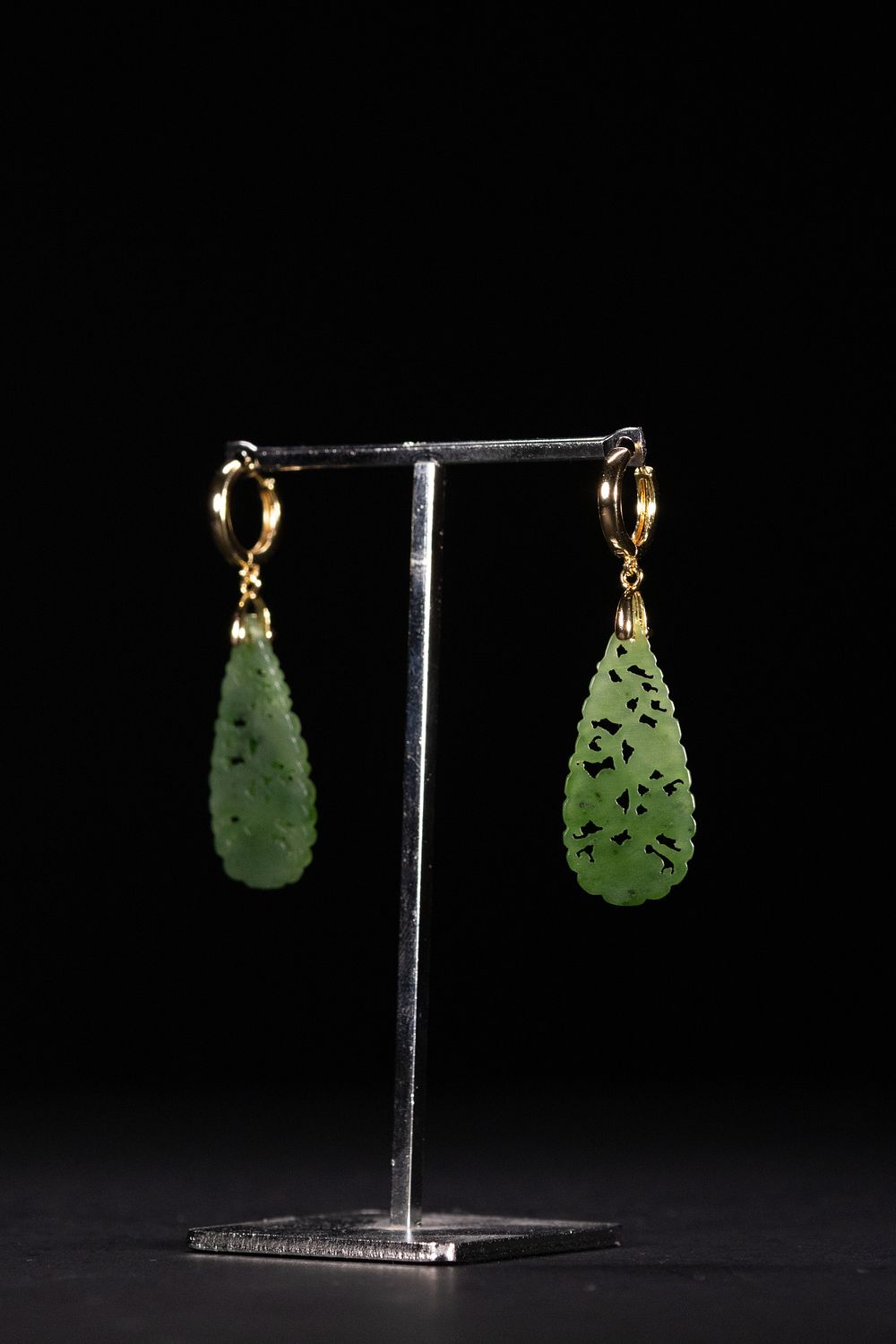 Lot 415: A Pair of Chinese Carved Green Jade Earrings.