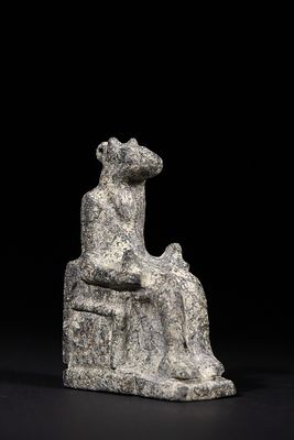 An Egyptian Stone Figurine of a Seated Animal-Headed Deity, Late Period of Egypt or Later. - An 