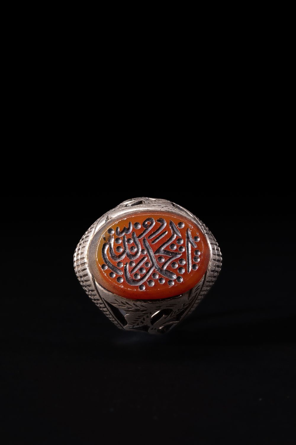 Lot 165: An Islamic Silver Ring with Oval Agate Intaglio...