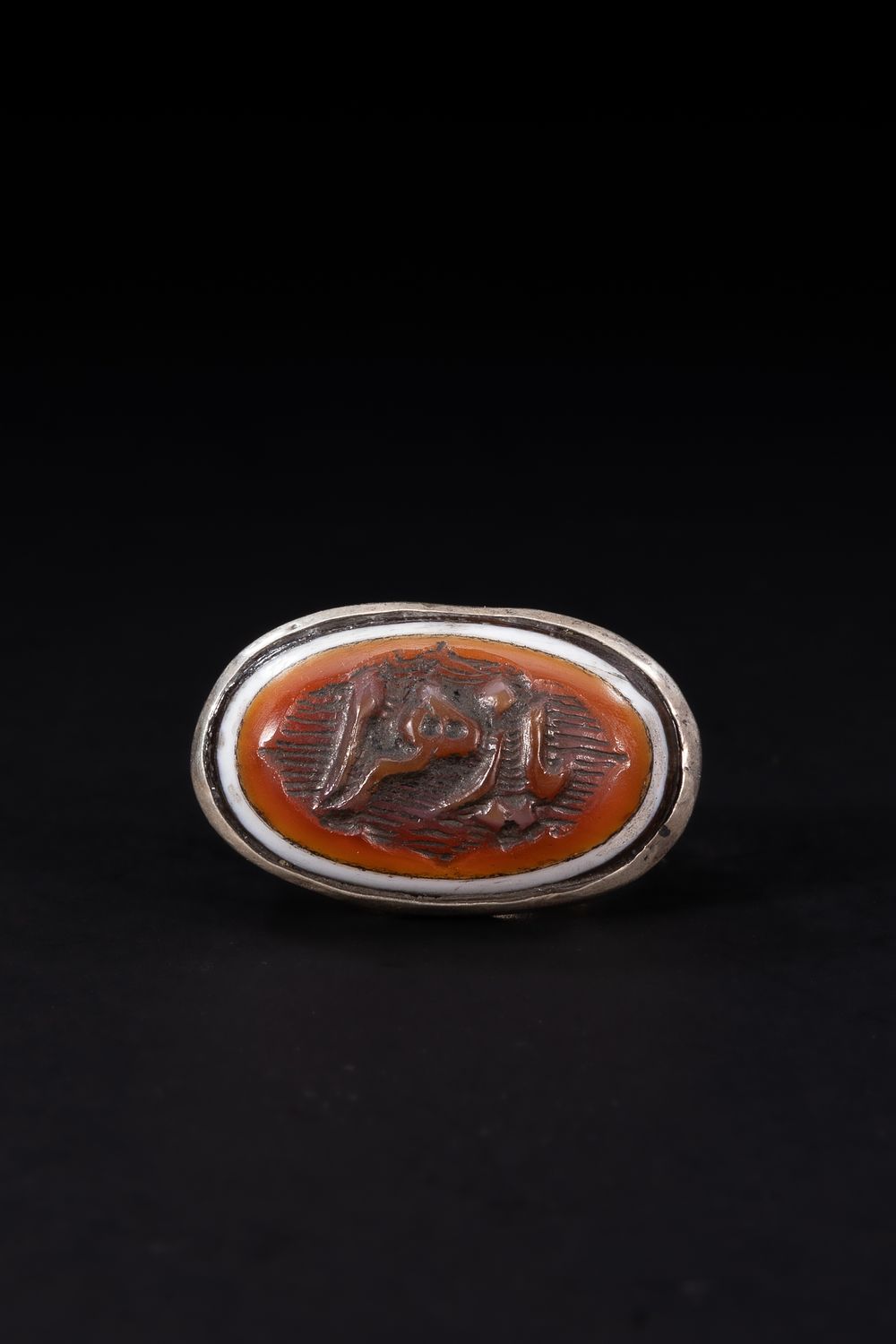 Lot 174: An Islamic Silver Ring Set with an Oval...