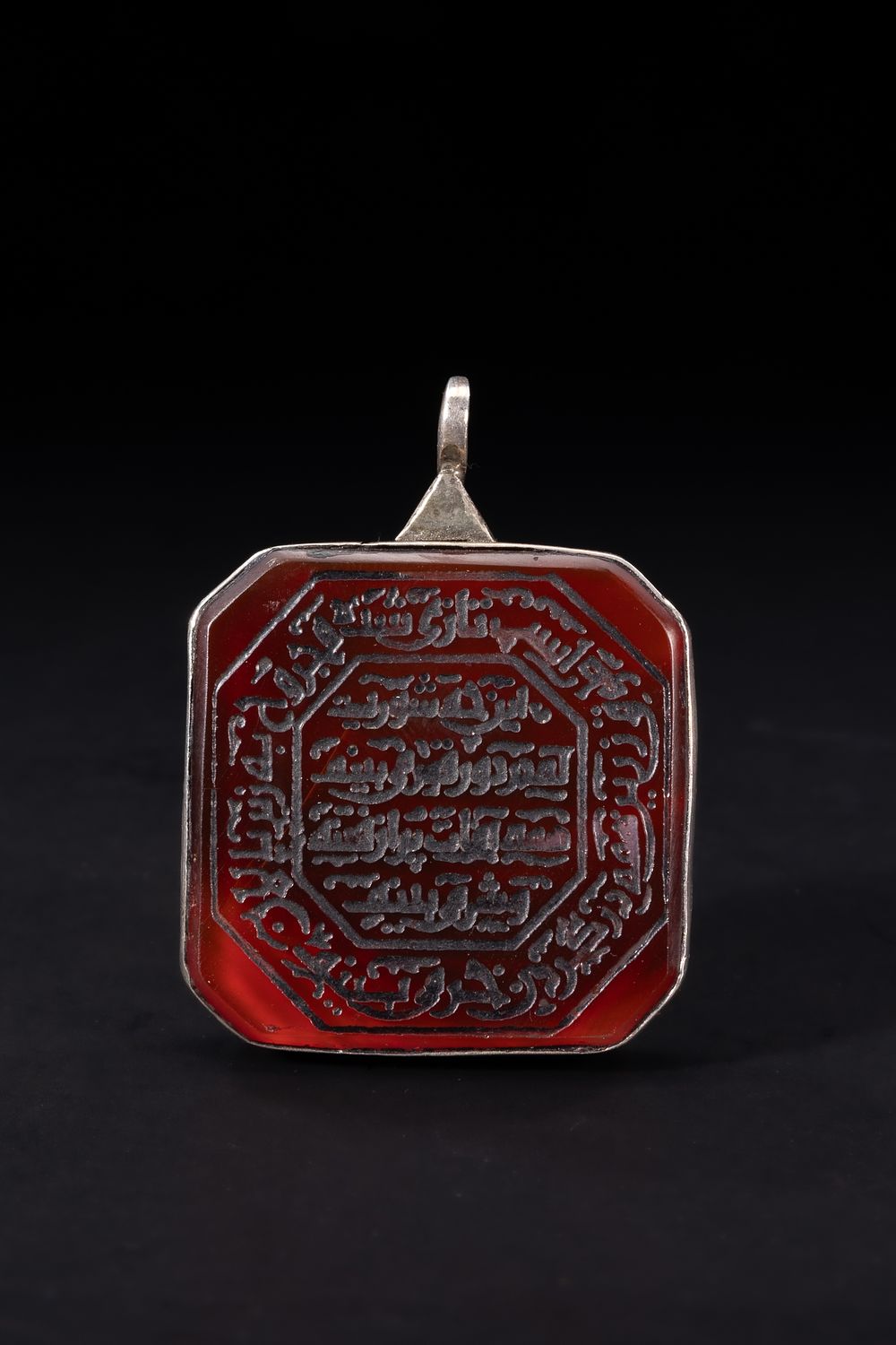 Lot 175: An Islamic Square Red Agate Amulet Pendant with...