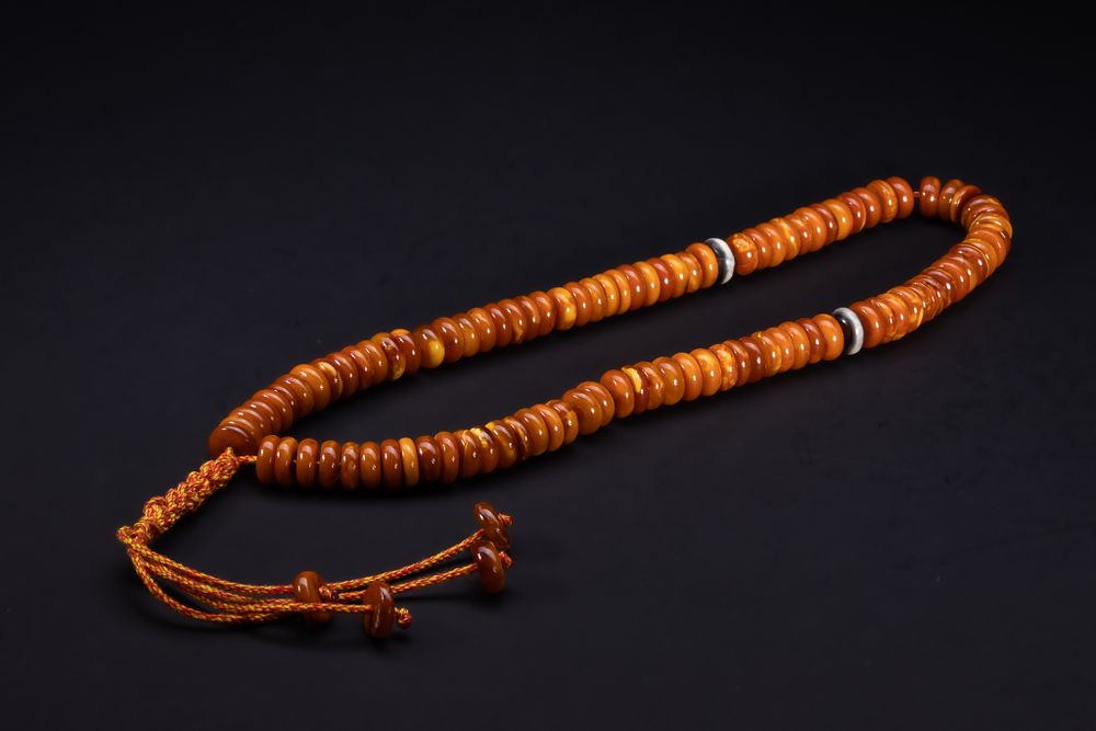 Lot 184: An Islamic Butterscotch Amber Bead Strand.