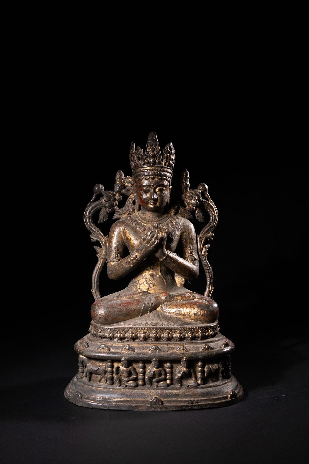 Lot 242: A Tibetan Gilt-Bronze Figure of a Seated Deity...