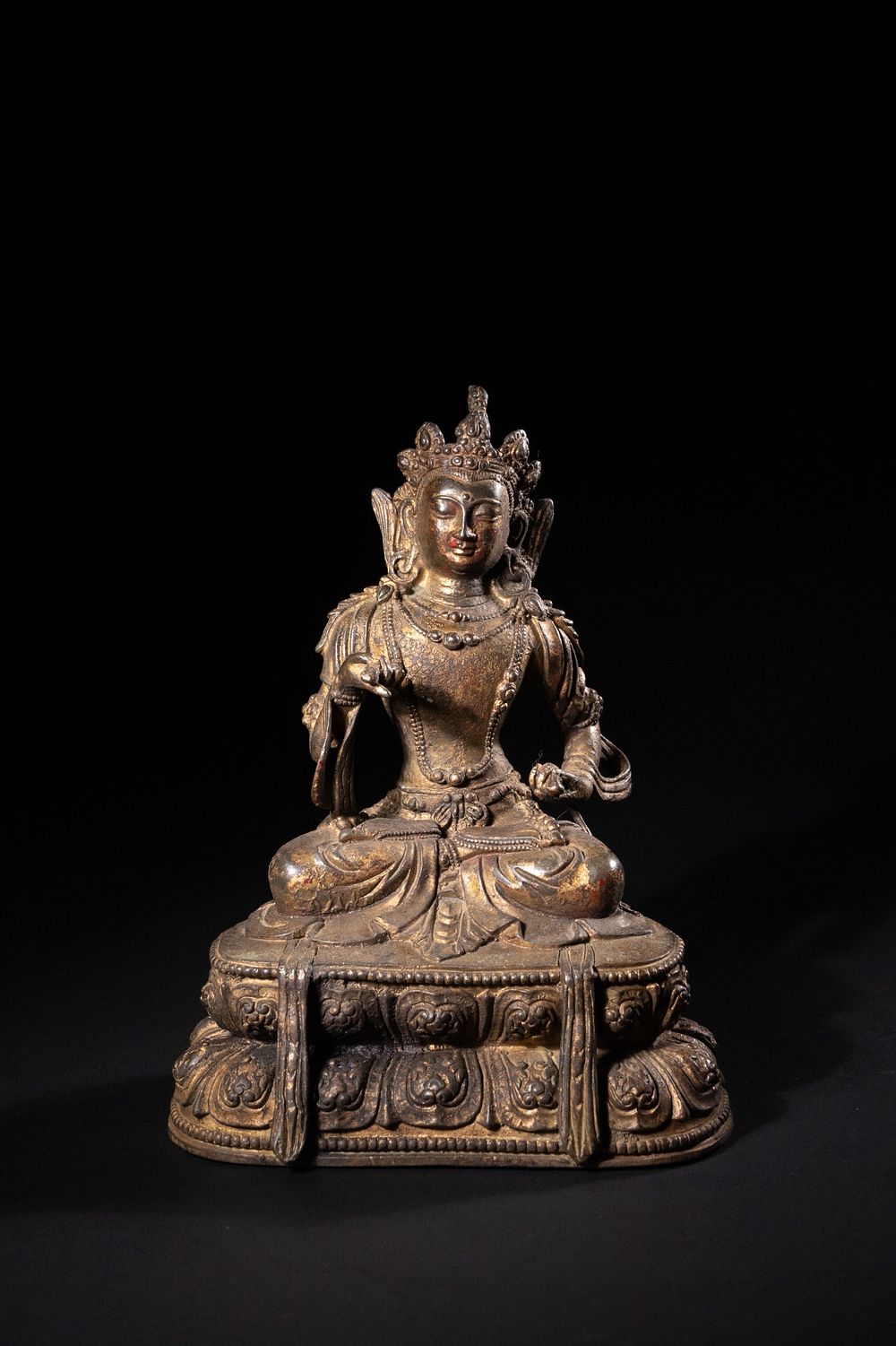 Lot 243: A Tibetan Gilt-Bronze Figure of a Seated Bodhisattva...