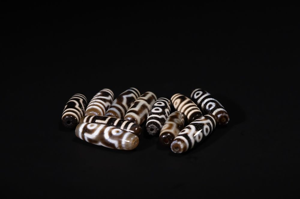 Lot 245: A Lot of Eleven Tibetan Agate Dzi Beads,...