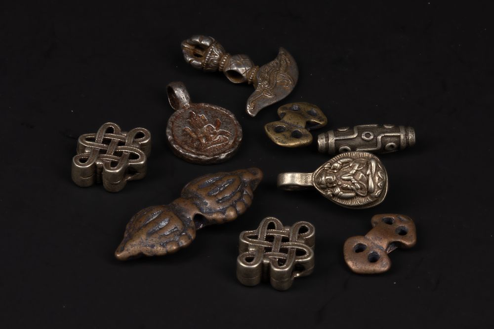 Lot 250: A Collection of Tibetan Mixed-Metal Ritual and Amuletic...