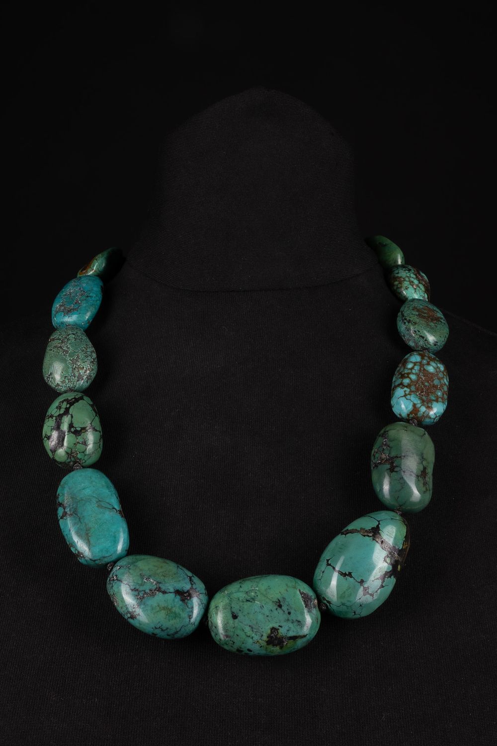 Lot 255: A Tibetan Turquoise Bead Necklace with Silver Clasp.