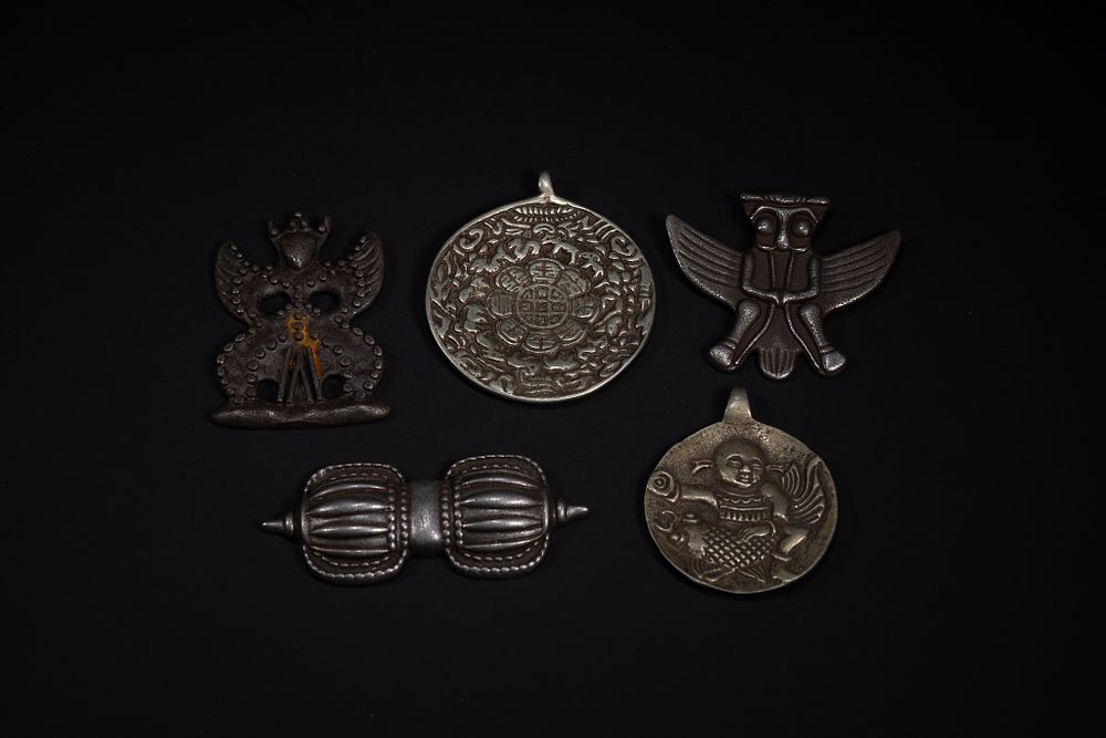 Lot 264: A Group of Tibetan White Metal Amulets and...