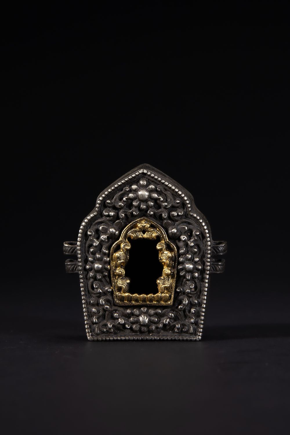 Lot 265: A Tibetan White Metal and Brass Ghau Box.