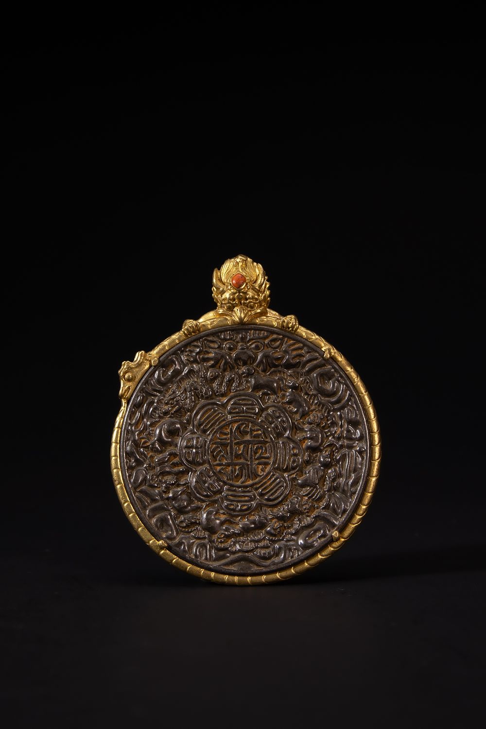 Lot 266: A Tibetan Iron and Brass Circular Talismanic Pendant...