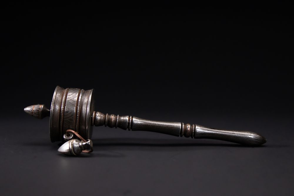 Lot 267: A Tibetan Iron Handheld Prayer Wheel.