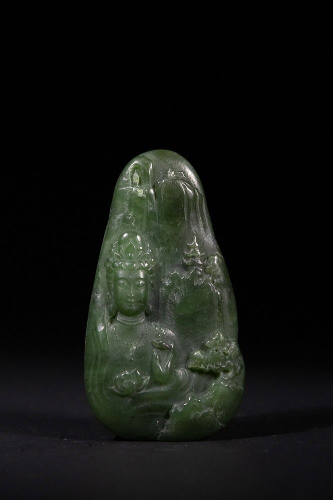 Lot 327: A Chinese Spinach Green Jade Carved Guanyin Figure...