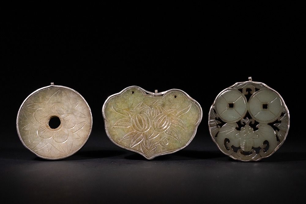 Lot 329: A Lot of Three Chinese Carved Jade Pendants...