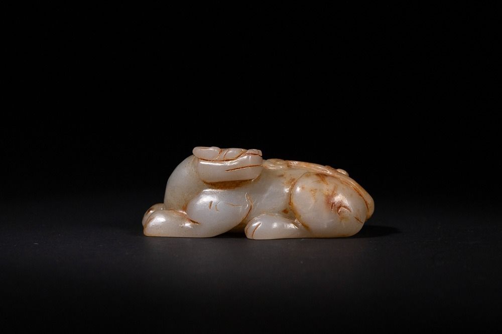 Lot 340: A Chinese Carved Jade Recumbent Mythical Beast -...
