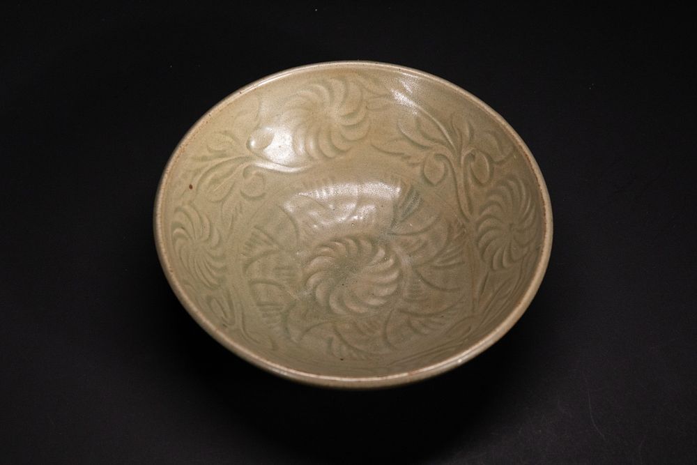 Lot 359: A Chinese Celadon Bowl with Incised Peony Motif.