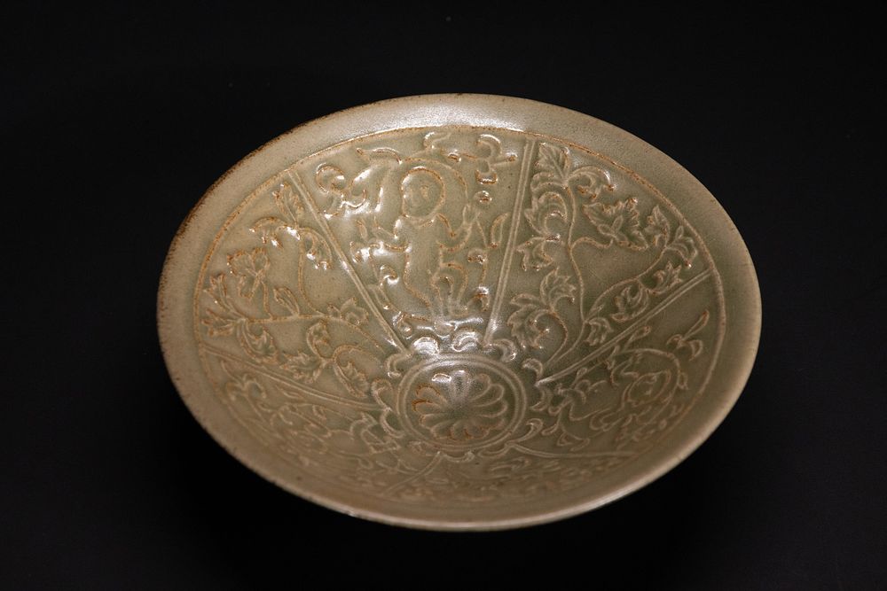 Lot 360: A Chinese Celadon-Glazed Carved Bowl.