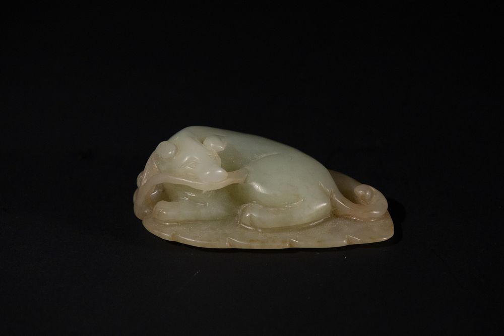 Lot 383: A Chinese Celadon Jade Carving of a Recumbent...