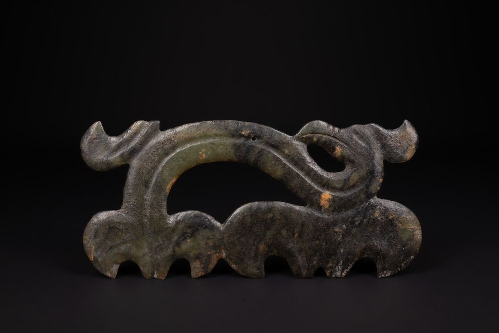Lot 395: A Chinese Archaic Openwork Dark Jade Dragon Ornament.