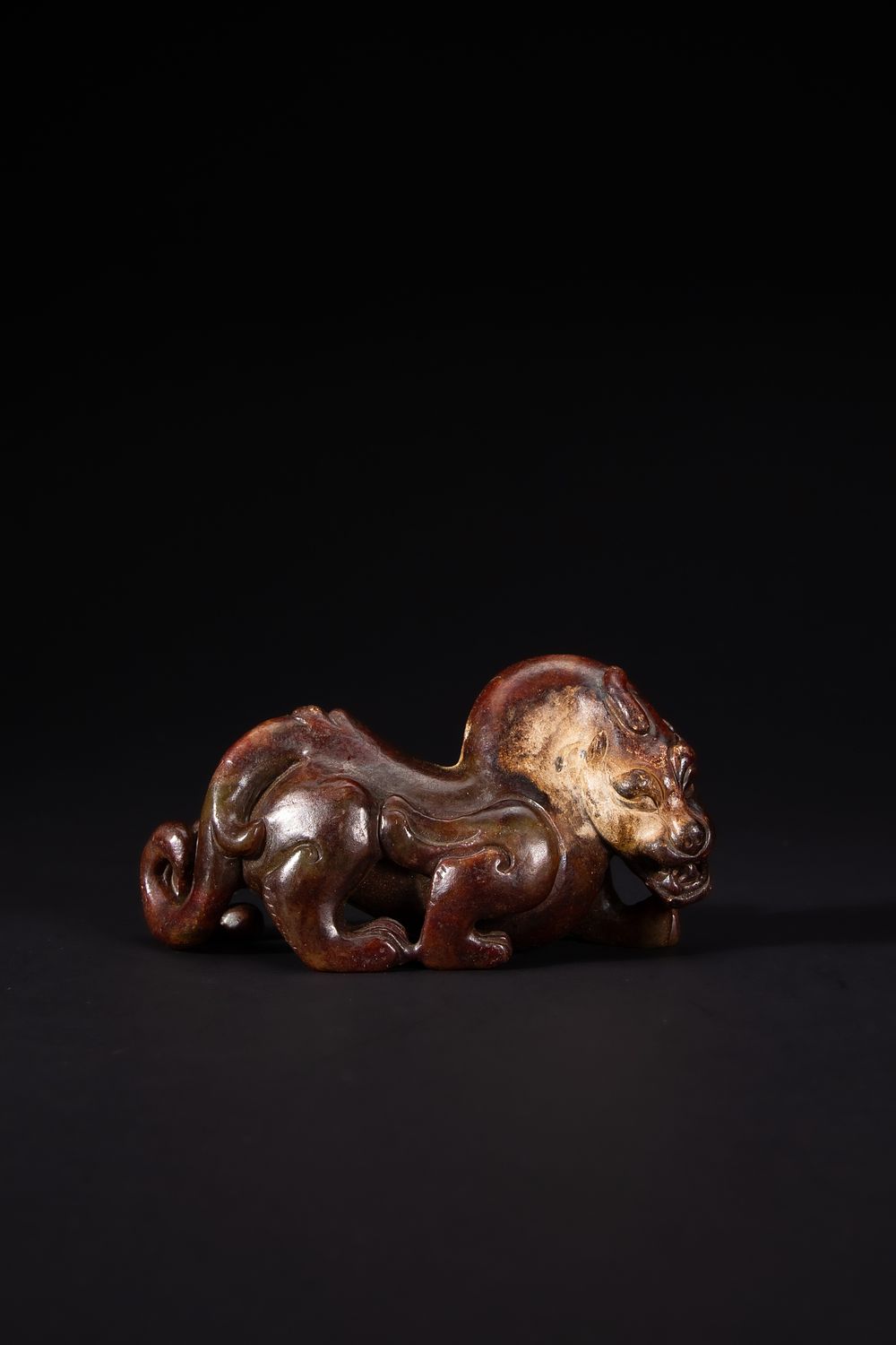 Lot 426: A Chinese Jade Recumbent Mythical Beast.