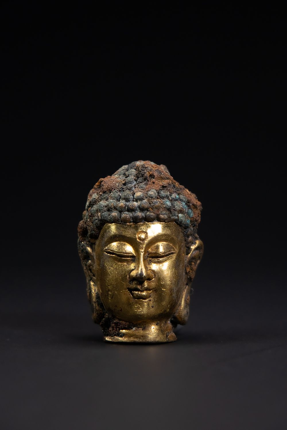 Lot 434: A Chinese Gilt Bronze Buddha Head, 19th Century.