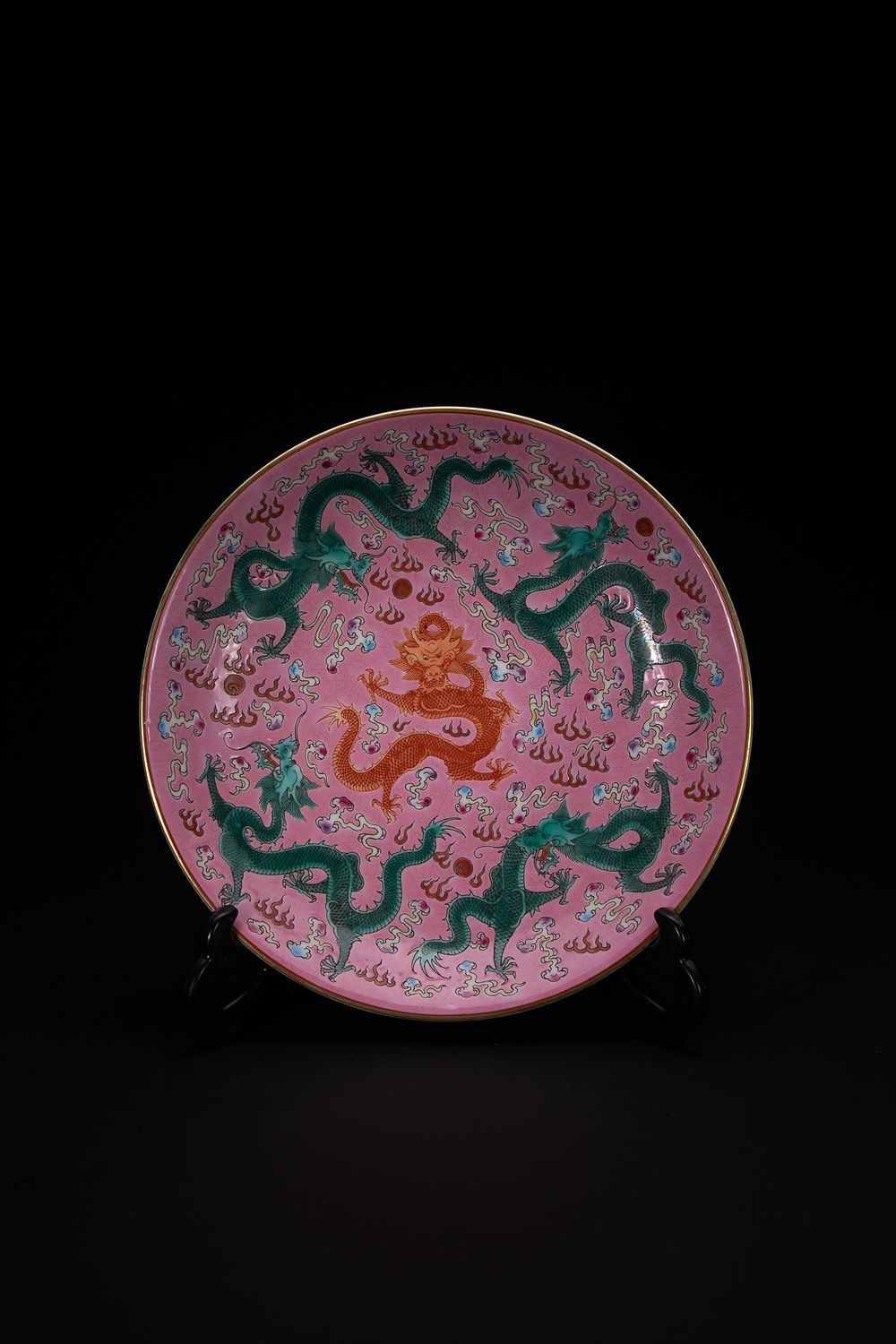 Lot 443: A Chinese Pink-Ground ‘Five Dragons’ Plate, Qianlong Mark.