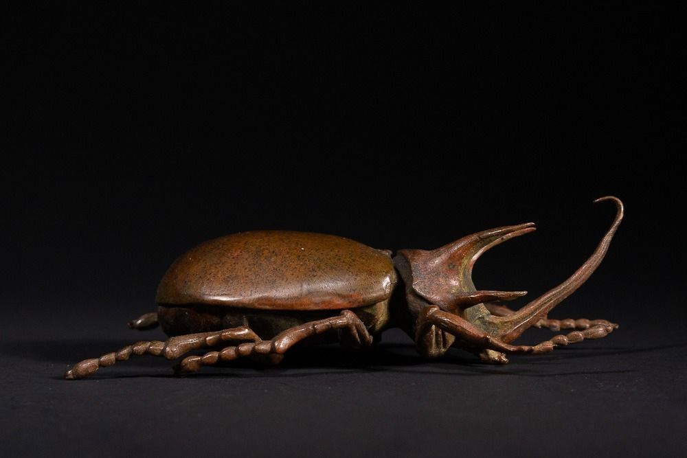 Lot 465: A Japanese Bronze Rhinoceros Beetle Okimono with Opening...