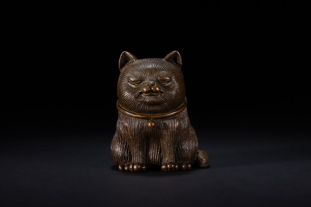 Lot 485: A Japanese Bronze Okimono of a Seated Cat.