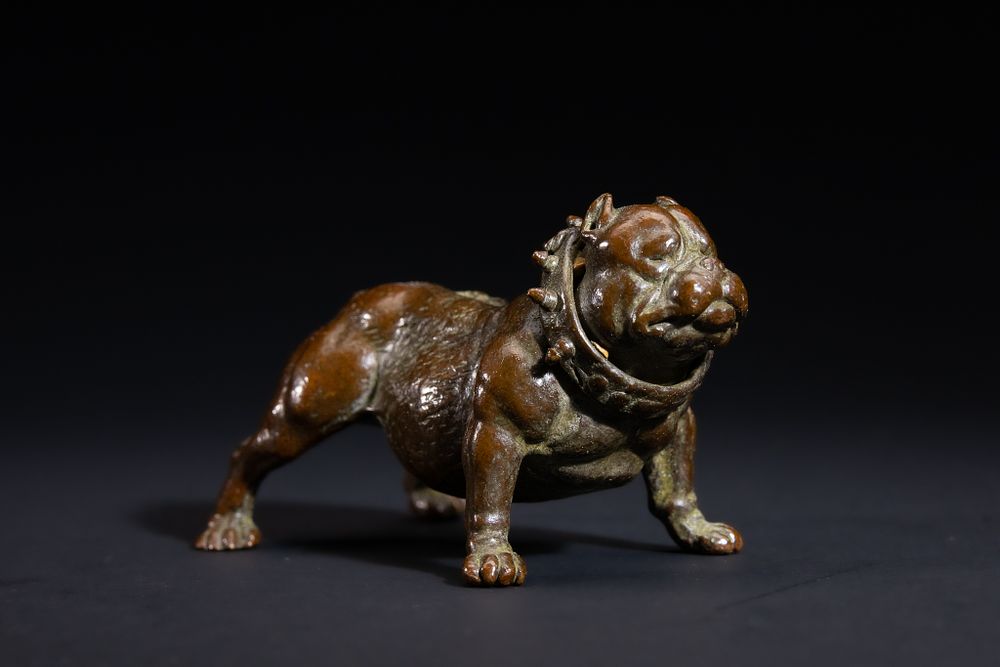Lot 487: A Japanese Bronze Model of a Recumbent Bulldog...