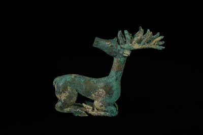 A Luristani Bronze Recumbent Stag Figure, circa 1st Millennium BCE. A cast Luristani bronze 