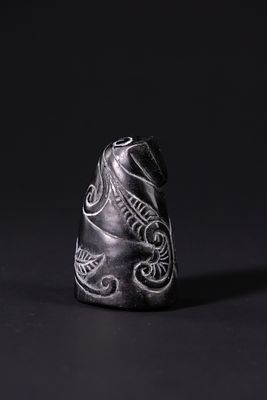 A Carved Black Stone Chess Knight with Foliate Decoration, 20th Century. A sculptural black 