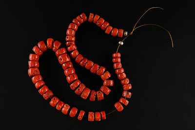 A Strand of African Red Coral Trade Beads. A striking strand composed of irregular cylindrical 