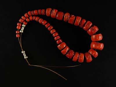 A Strand of African Natural Coral Beads. A striking strand composed of graduated natural coral 
