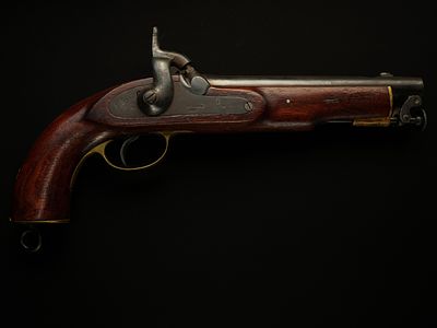 A Percussion Cap Travelling Pistol with Walnut Stock and Brass Mounts, 19th Century. A compact 