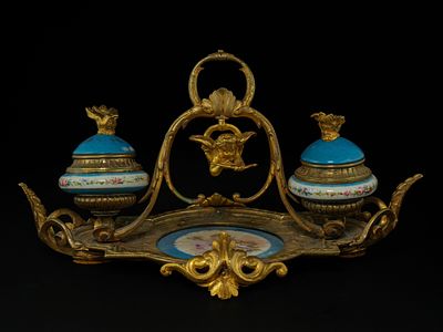 A French Gilt Bronze and Porcelain Double Inkwell Stand with Cherub, 19th Century. A decorative 