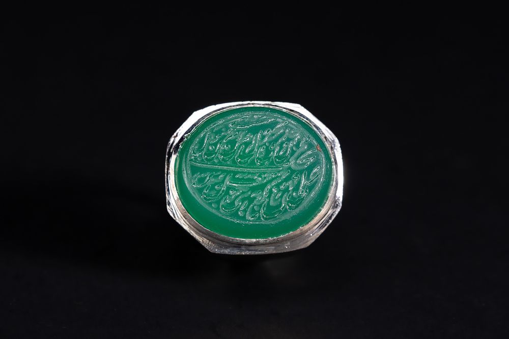 Lot 158: An Islamic Silver Ring Set with a Carved...