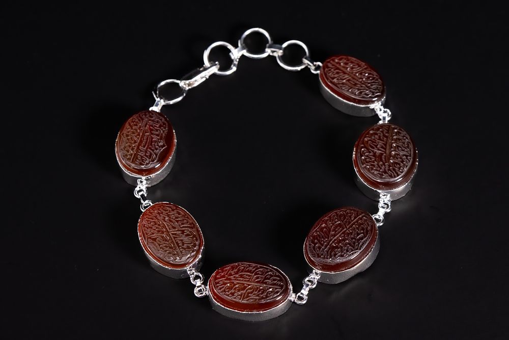 Lot 159: An Islamic Agate and White Metal Bracelet with...