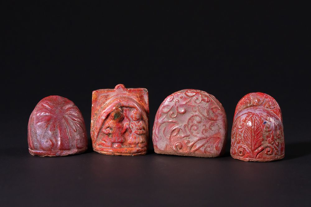 Lot 165: A Set of Four Islamic Red Glazed Chess...