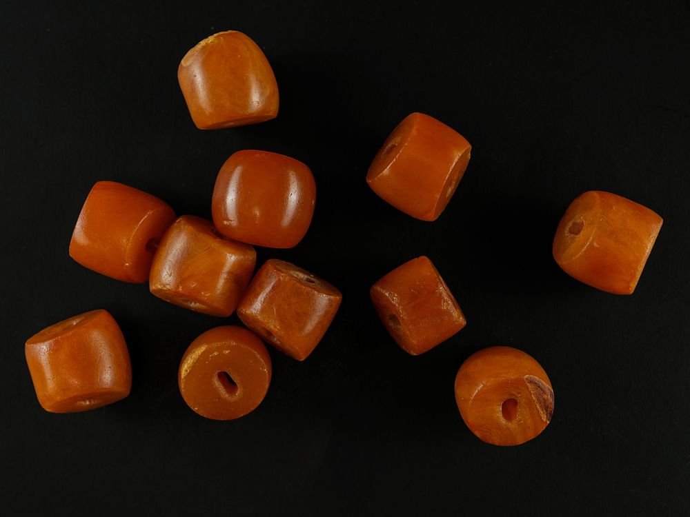 Lot 192: A Collection of Islamic Amber Rounded Beads.