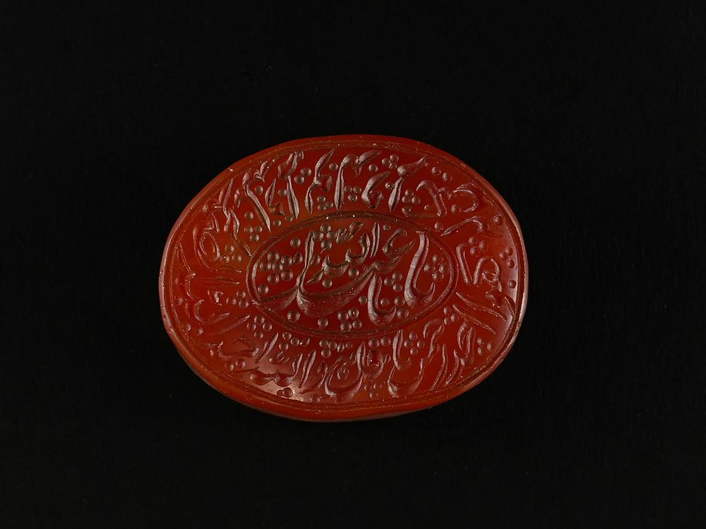Lot 194: An Islamic Carved Red Agate Intaglio Seal Stone...