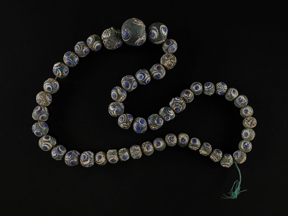 Lot 195: An Islamic Eye-Motif Glass Bead Necklace.