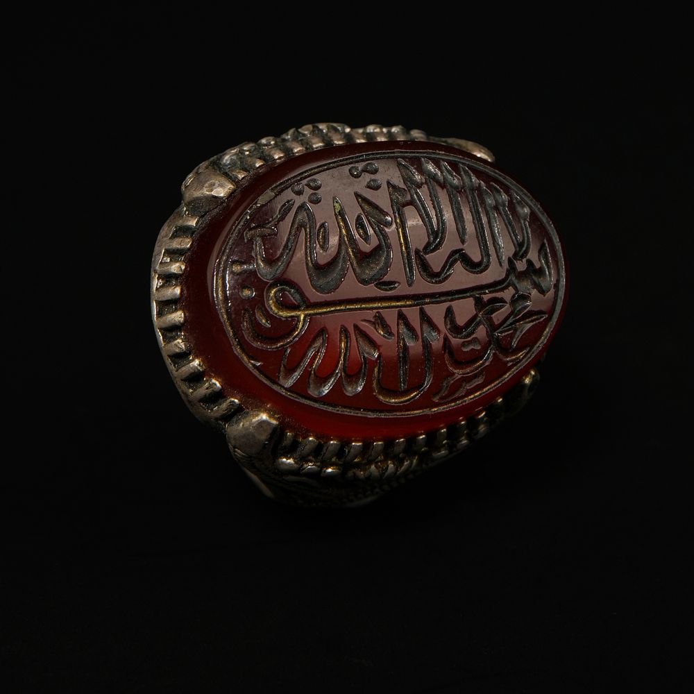 Lot 199: An Islamic Silver Ring Set with an Oval...