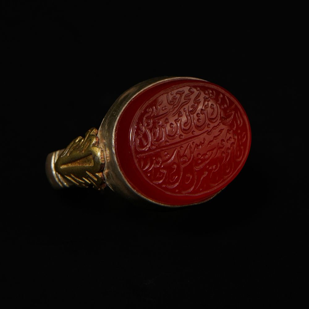 Lot 200: An Islamic Silver Ring with Red Agate Intaglio...