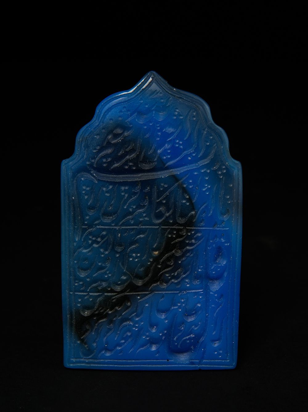 Lot 211: An Islamic Blue Glass Plaque with Carved Arabic...