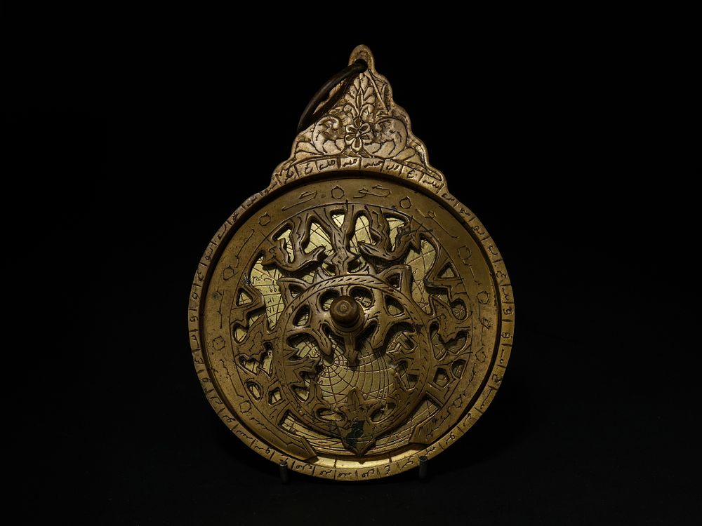 Lot 215: An Islamic Brass Astrolabe with Pierced Rete and...