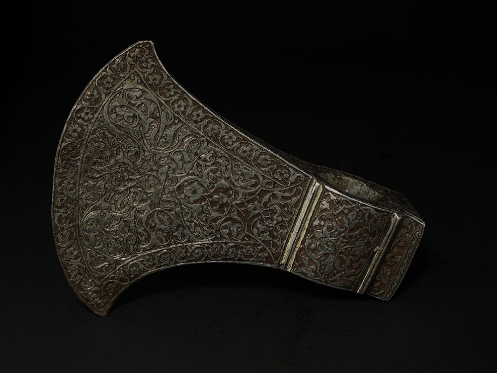 Lot 216: An Indo-Persian Engraved Axe Head with Dense Foliate...