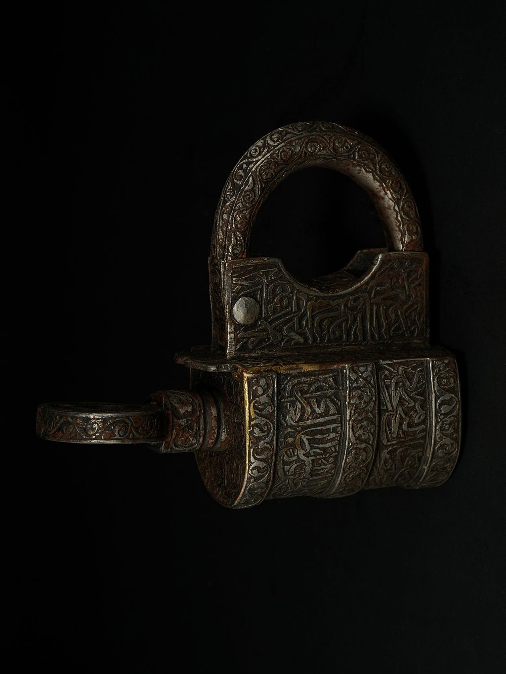 Lot 217: An Islamic Iron Padlock with Calligraphic Inscriptions.