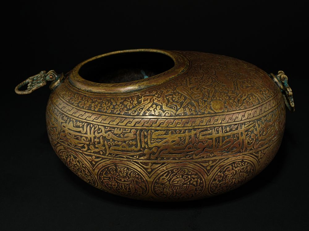 Lot 220: A Qajar Brass Kashkul Beggar’s Bowl with Figural...